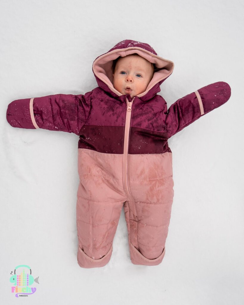 baby in a snowsuit winter photoshoot snow photoshoot happy baby