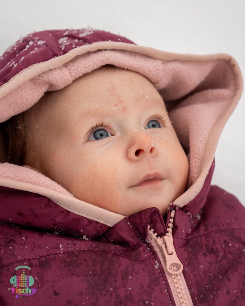 baby in a snowsuit winter photoshoot snow photoshoot happy baby