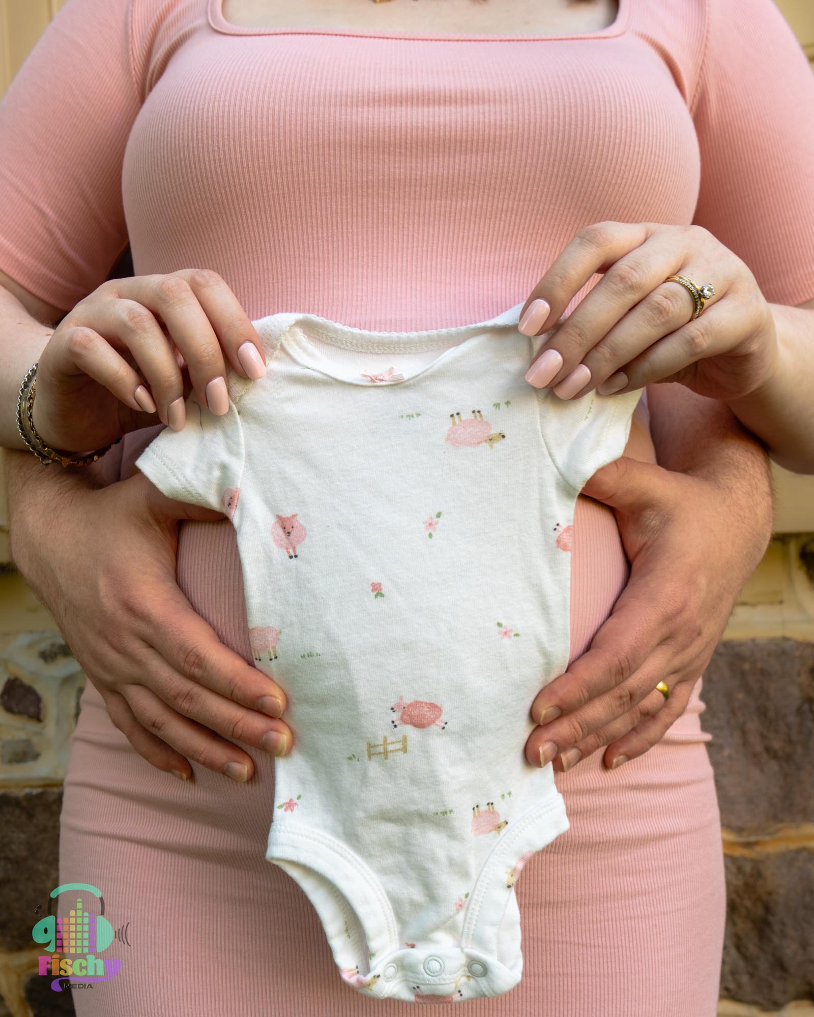 couple holding baby outfit
maternity photoshoot
young couple