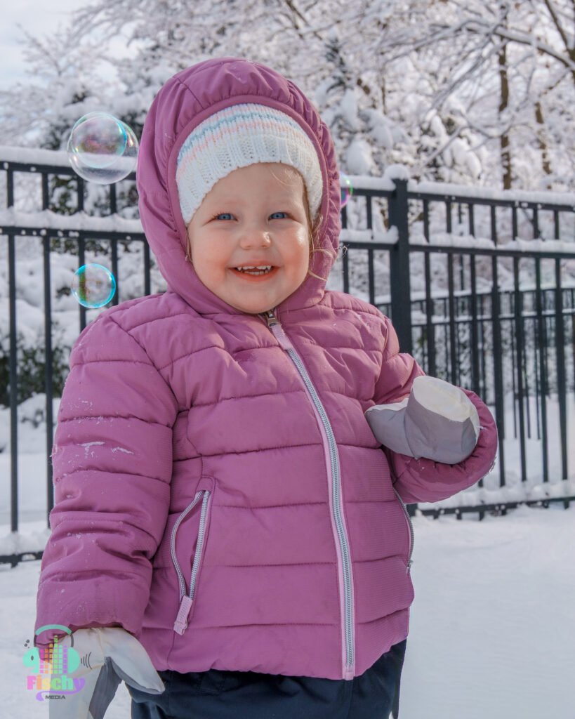 toddler in a snowsuit snow photoshoot family photoshoot baby photoshoot