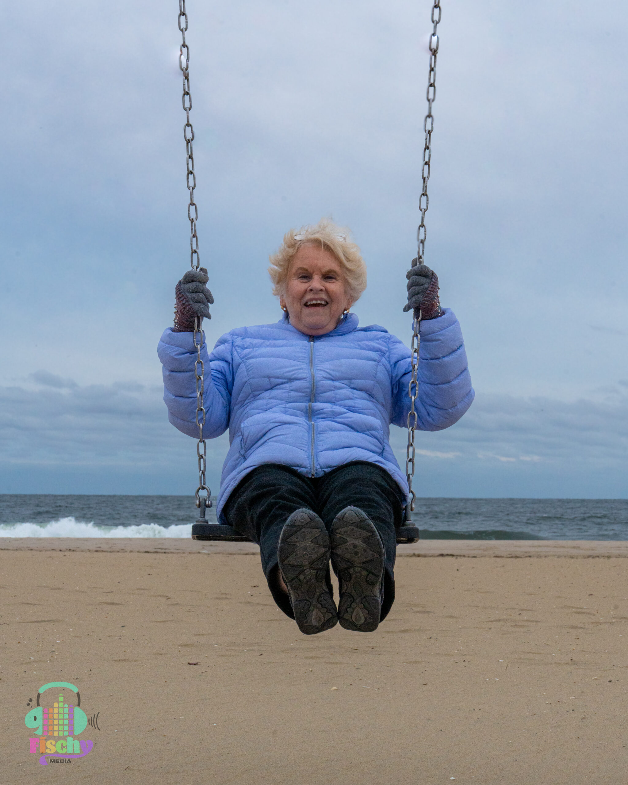 Older lady on a swing beach photoshoot