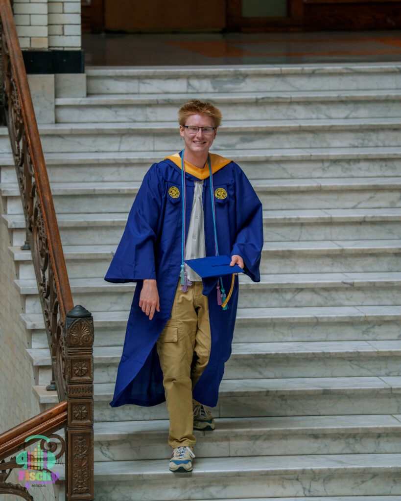college graduate boy
graduate wearing cap and gown
drexel
graduation photoshoot
grad pics