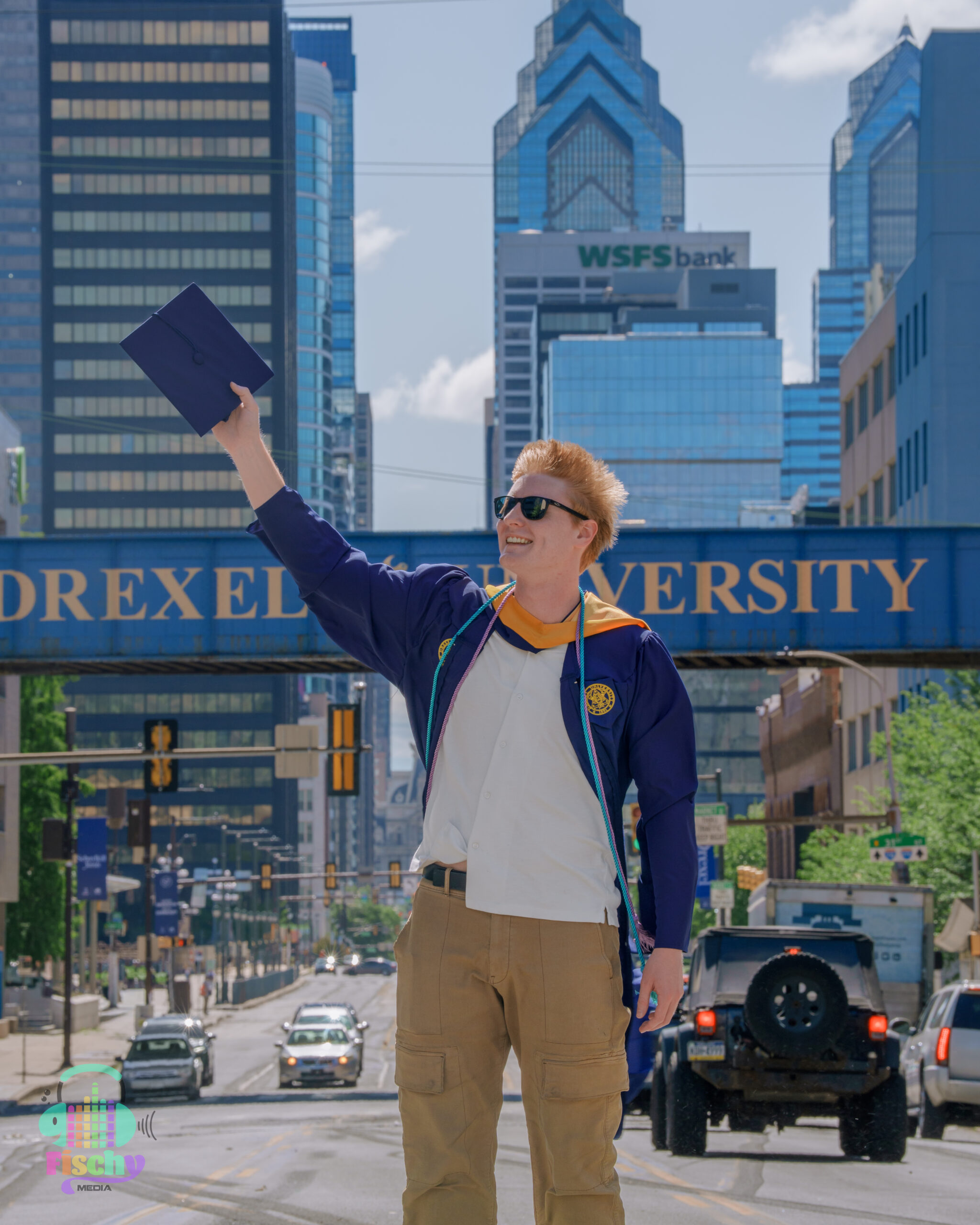 college graduate boy
graduate wearing cap and gown
drexel
graduation photoshoot
grad pics
