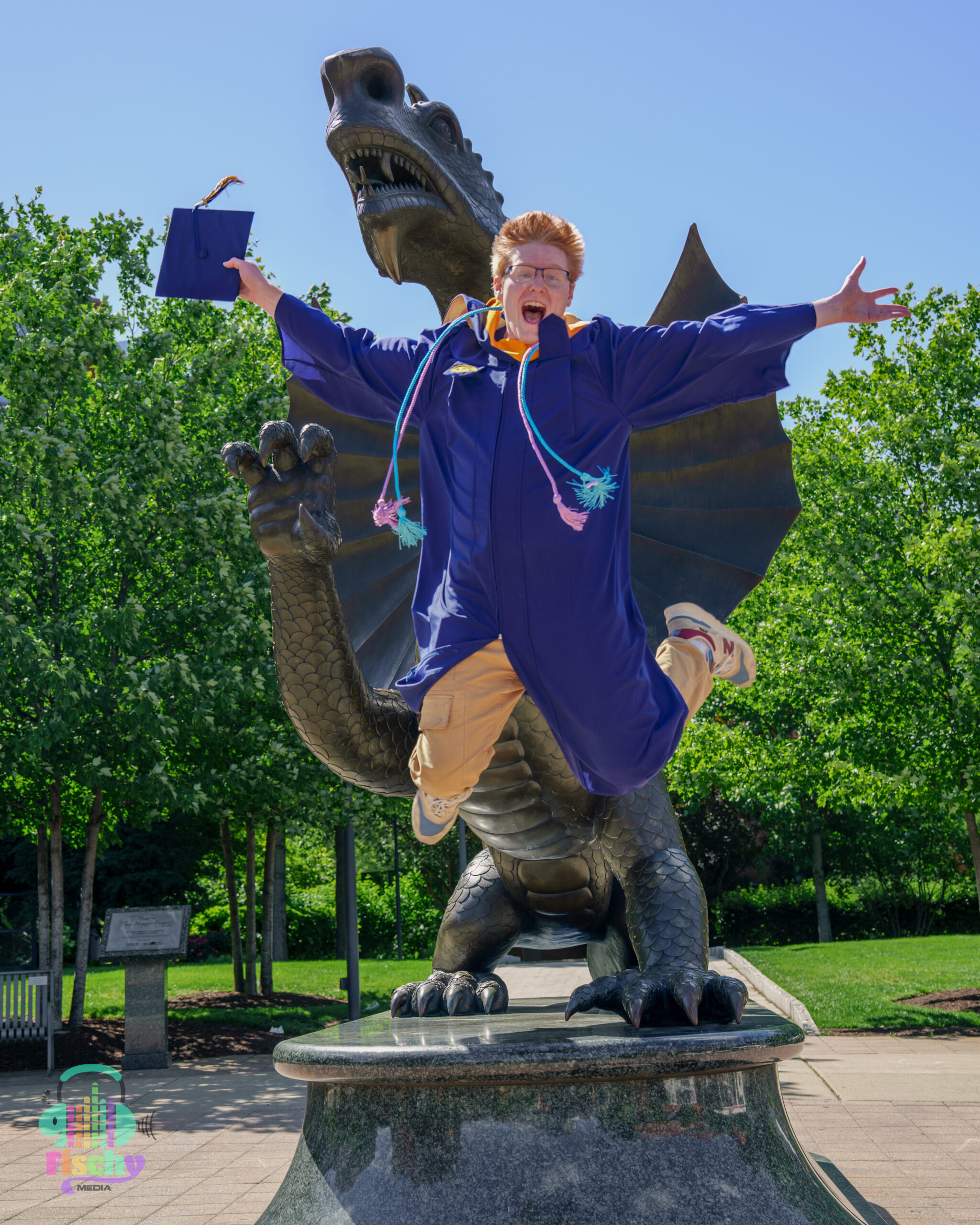 college graduate boy
graduate wearing cap and gown
drexel
graduation photoshoot
grad pics