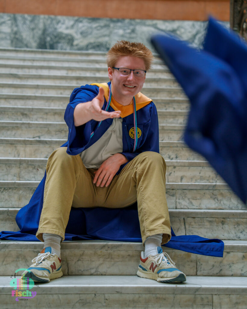 college graduate boy
graduate wearing cap and gown
drexel
graduation photoshoot
grad pics